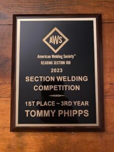 AWS plaque proclaiming Tommy Phipps first place in section welding competition in his 3rd year.