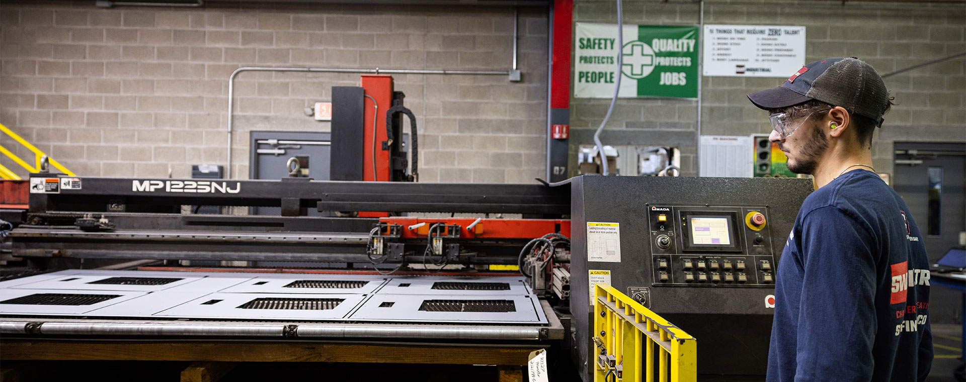 Metal fabrication employee performing a quality assurance check